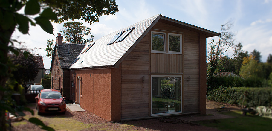 Rural cottage extension with zinc roof and steel frame structure to create open plan living spaces