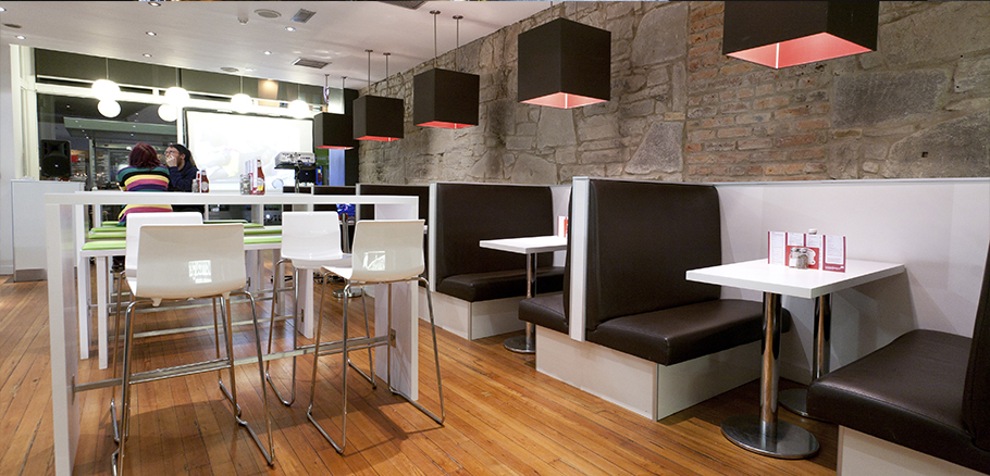 Interior design with booth seating and original stone walls.